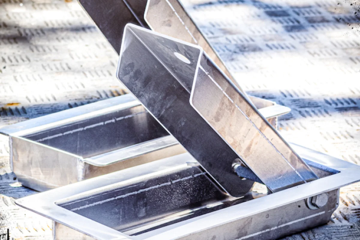 A FLIP chock pivoted open out of its recessed tray in a trailer floor